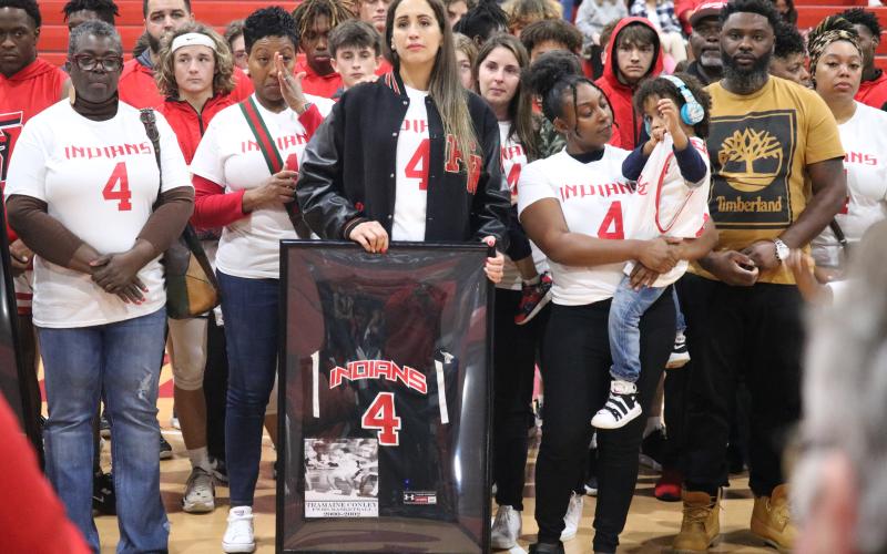 Samira Conley, the wife of Tramaine Conley, holds back tears after being presented with his Fort White jersey prior to Thursday’s game against Bell. (JORDAN KROEGER/Lake City Reporter)