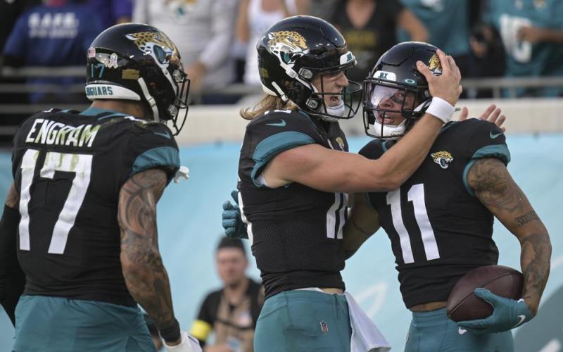 Jacksonville Jaguars wide receiver Marvin Jones Jr. (11) is congratulated by Jacksonville Jaguars quarterback Trevor Lawrence (16) after a touchdown during the second half of an NFL football game against the Baltimore Ravens on Nov. 27 in Jacksonville. (PHELAN M. EBENHACK/Associated Press)