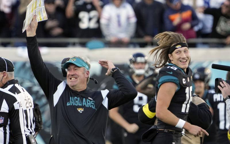Jacksonville Jaguars head coach Doug Pederson (left) celebrates with Jacksonville Jaguars quarterback Trevor Lawrence (16) after defeating the Dallas Cowboys in overtime on Sunday in Jacksonville. (JOHN RAOUX/Associated Press)