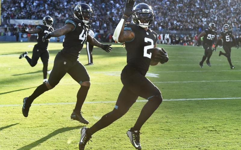 Jacksonville Jaguars safety Rayshawn Jenkins (2) celebrates with linebacker Josh Allen (41) and linebacker Devin Lloyd (33) after his game-winning pick-6 against the Dallas Cowboys in overtime on Sunday in Jacksonville. (BOB SELF/The Florida Times-Union via AP)
