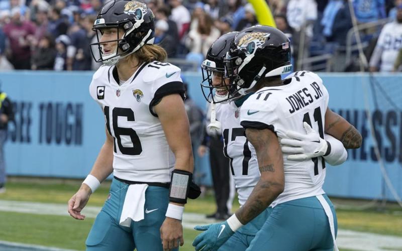 Jacksonville Jaguars tight end Evan Engram runs with the ball as Tennessee Titans safety Andrew Adams (47) and linebacker Bud Dupree (48) defend during Sunday's game in Nashville, Tenn. (CHRIS CARLSON/Associated Press)