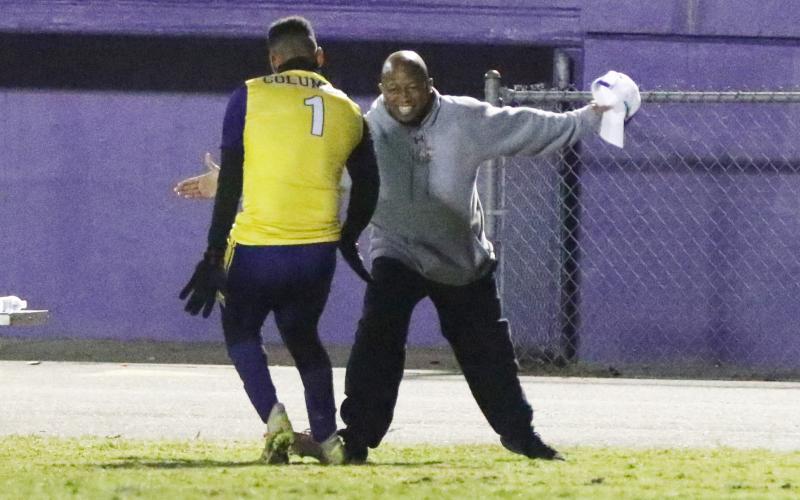 Columbia’s AJ Brinson (1) celebrates with head coach Ed Turner after scoring his first goal against Eastside on Friday night. (MORGAN MCMULLEN/Lake City Reporter)