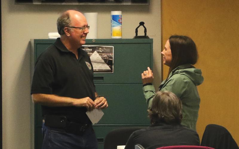 Emergency Management Director Shayne Morgan (left) and county spokeswoman Paula Vann converse at the county’s Combined Communications Center during Hurricane Ian’s landfall in September. Morgan will now be part of the team managing logistics for Gov. Ron DeSantis’ inauguration ceremony next week. (FILE)