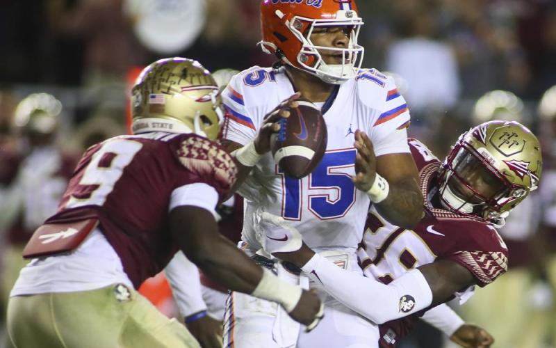 Florida State defensive end Derrick McLendon II (9) and defensive back Shyheim Brown (38) sack Florida quarterback Anthony Richardson (15) on Nov. 25 in Tallahassee. (PHIL SEARS/Associated Press)
