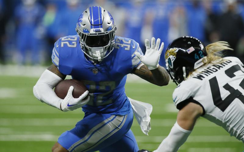 Detroit Lions running back D'Andre Swift rushes past Jacksonville Jaguars safety Andrew Wingard (42) during Sunday's game in Detroit. (DUANE BURLESON/Associated Press)