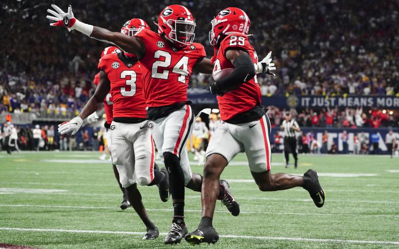 Georgia defensive back Malaki Starks (24) reacts as Georgia defensive back Christopher Smith (29) returns a blocked LSU field goal attempt for a touchdown in the SEC championship game on Saturday in Atlanta. (JOHN BAZEMORE/Associated Press)