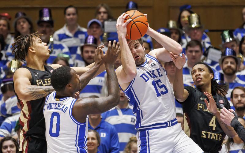 Duke's Ryan Young (15) grabs a rebound ahead over Dariq Whitehead (0), Florida State's Caleb Mills (4), and Cam Corhen (3) on Dec. 31 in Durham, N.C. (BEN MCKEOWN/Associated Press)