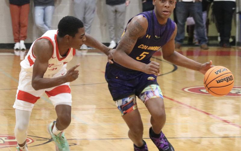 Columbia guard Jerome Carter dribbles up the court against Santa Fe last Friday. (JORDAN KROEGER/Lake City Reporter)