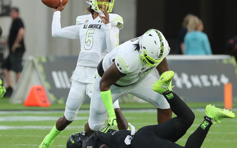 Jaden Rashada throws over the block of teammate Cayden Green during the Under Armour Next All-American Game at Camping World Stadium on Jan. 3 in Orlando. (STEPHEN M. DOWELL/TNS)