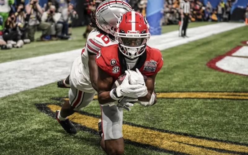 Georgia wide receiver Adonai Mitchell (5) makes a touchdown catch against Ohio State cornerback Denzel Burke (10) during the second half of the Peach Bowl NCAA college football semifinal playoff game, Saturday, Dec. 31, 2022, in Atlanta. Brynn Anderson/Associated Press)