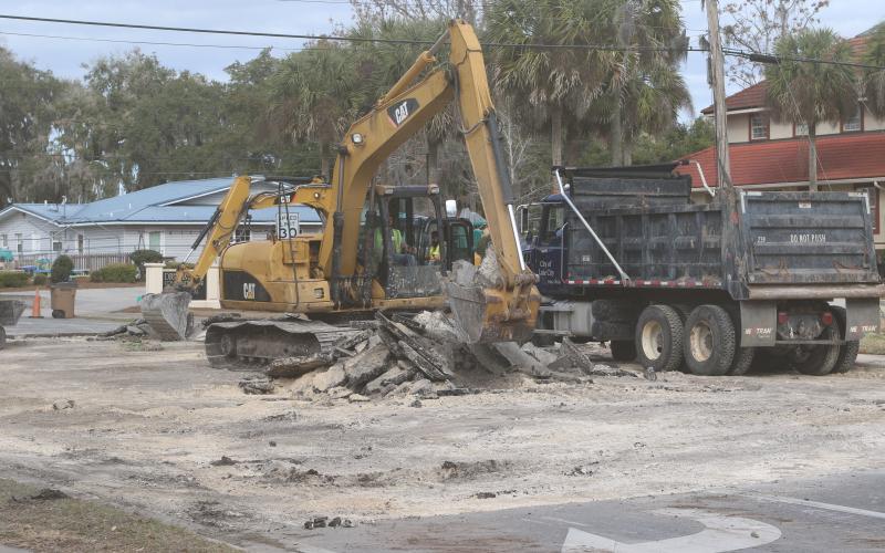City crews clean up Lake Jeffery Road on Tuesday afternoon after repairing a broken water line on the road near the intersection with NW Orange Street. The line was broken by a contractor installing fiberoptic cables. (JAMIE WACHTER/Lake City Reporter)