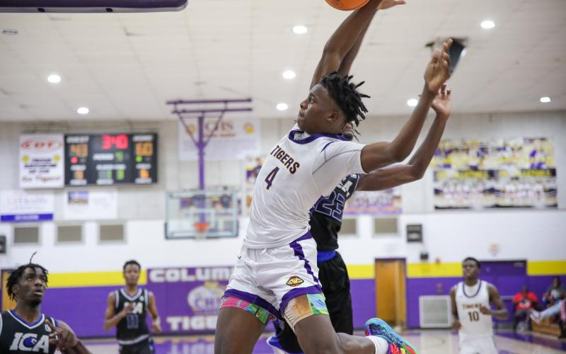 Columbia forward Ty'jahn Wright flies down the baseline for a dunk against Impact Christian Academy last Thursday. (BRENT KUYKENDALL/Lake City Reporter)