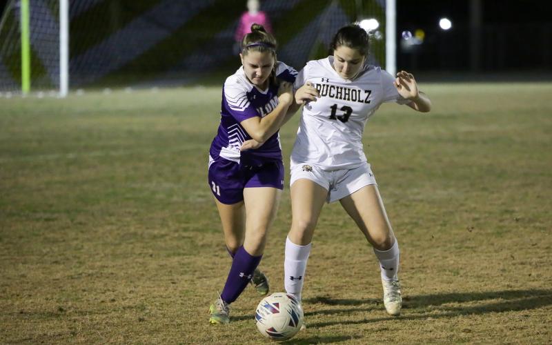 Columbia’s Sydney Rivas (left) battles for control of the ball with Buchholz’s Zoe Torres during Tuesday night’s game at Tiger Stadium. Torres scored a goal for her side in the 4-1 CHS loss. (BRENT KUYKENDALL/Special to the Reporter)