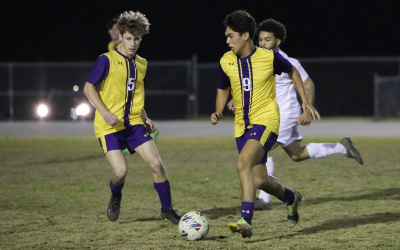 Columbia’s Bryson Kyi (9) dribbles the ball up the field alongside Johnathan Pineda (5) against Palatka on Jan. 17. (BRENT KUYKENDALL/Lake City Reporter)