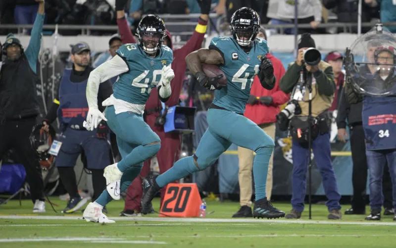 Jacksonville Jaguars linebacker Josh Allen (41) returns a fumble for a touchdown as defensive end Arden Key (49) covers against the Tennessee Titans on Saturday in Jacksonville. (PHELAN M. EBENHACK/Associated Press)