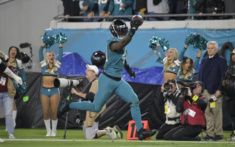 Jacksonville Jaguars linebacker Josh Allen returns a fumble for a touchdown during Saturday's game against the Tennessee Titans in Jacksonville. ( PHELAN M. EBENHACK/Associated Press)