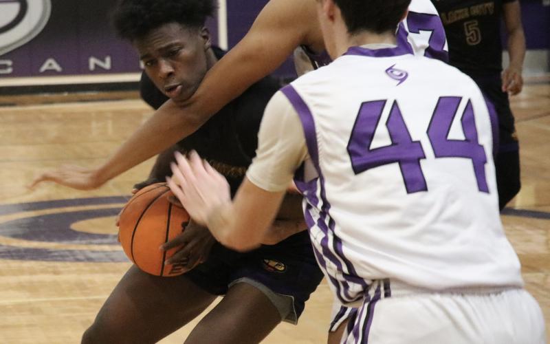 Columbia’s Ty’jahn Wright gets hit by Hurricanes defender Josh Hayes during Tuesday night’s game in Gainesville. (JORDAN KROEGER/Lake City Reporter)
