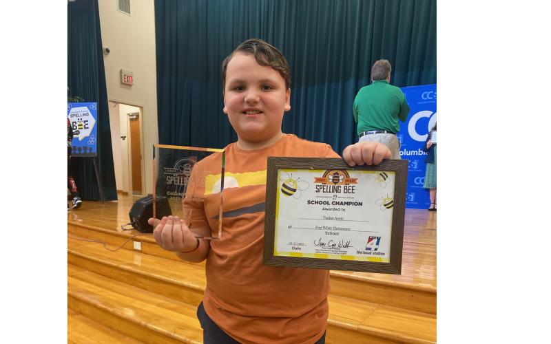 Fort White Elementary School’s Tucker Ayers shows off his awards for winning the Columbia County Spelling Bee on Friday. (COURTESY)