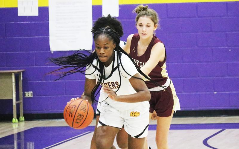 Columbia guard Eriel Baker pushes the ball up the court after stealing it away from Oak Hall guard Bella Gloriod on Friday night. (JORDAN KROEGER/Lake City Reporter)