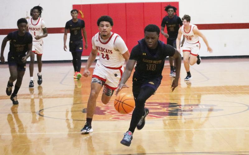 Columbia guard Isaac Broxey comes up with a steal that turned into a dunk against Baker County on Friday. (JORDAN KROEGER/Lake City Reporter)