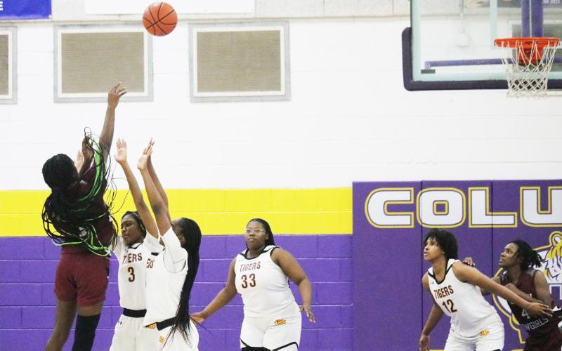 Madison County guard Janiyah McKnight makes the game-winning shot at the buzzer over Columbia guards Ryann Potter and Eriel Baker on Tuesday night. (JORDAN KROEGER/Lake City Reporter)