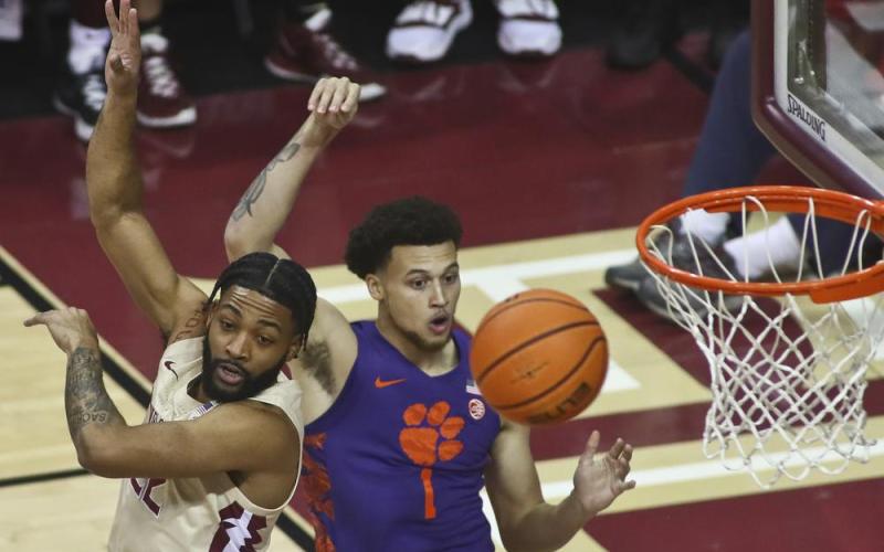 Florida State guard Darin Green, Jr. and Clemson guard Chase Hunter position themselves for a rebound on Saturday in Tallahassee. (PHIL SEARS/Associated Press)