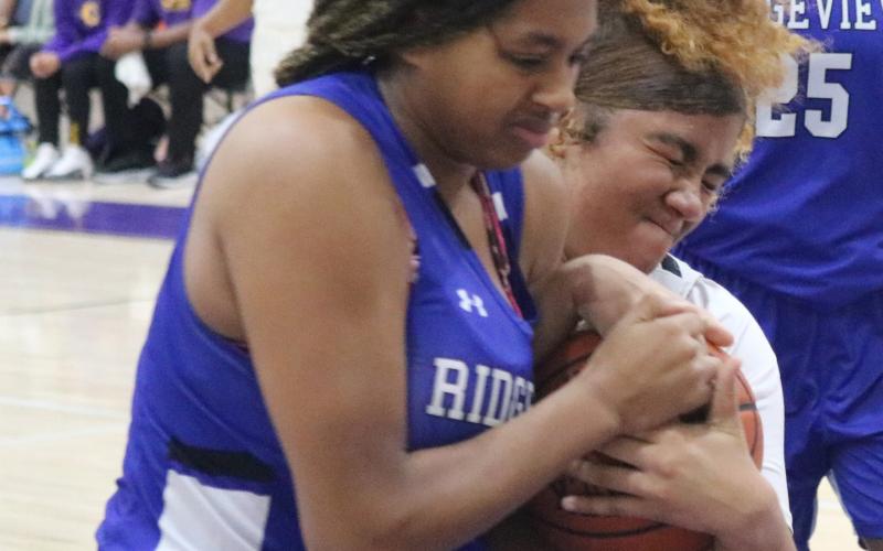 Columbia center Khalea Clark fights for possession for the basketball with Ridgeview forward Nacoya Blocton during Monday night’s game. (JORDAN KROEGER/Lake City Reporter)