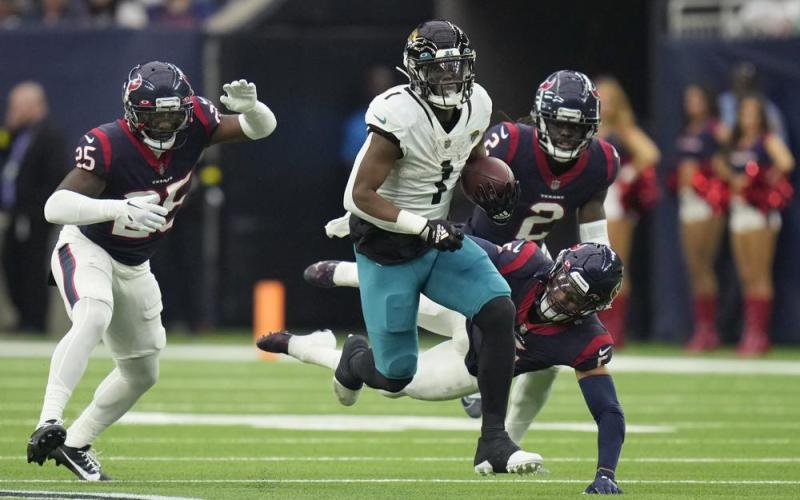 Jacksonville Jaguars running back Travis Etienne Jr. (1) runs for a touchdown against the Houston Texans during Sunday's game in Houston. (ERIC CHRISTIAN SMITH/Associated Press)