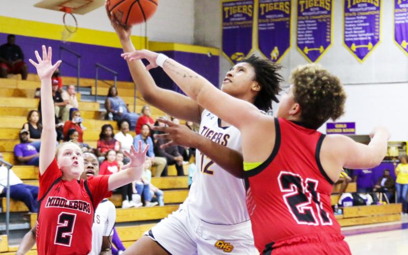 Columbia forward Jolena Gardner rises between Middleburg defenders Ruby Owen (2) and Cheyenne Jenkins (21) during Tuesday night’s District 2-5A quarterfinal. (BRENT KUYKENDALL/Lake City Reporter)
