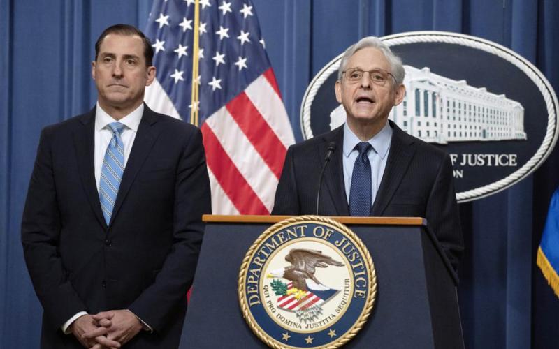 Attorney General Merrick Garland speaks during a news conference at the Department of Justice on Thursday in Washington as John Lausch, the U.S. Attorney in Chicago, looks on. (MANUEL BALCE CENETA/Associated Press)
