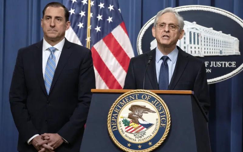 Attorney General Merrick Garland speaks during a news conference at the Department of Justice on Thursday in Washington, as John Lausch, the U.S. Attorney in Chicago, looks on. (MANUEL BALCE CENETA/Associated Press)