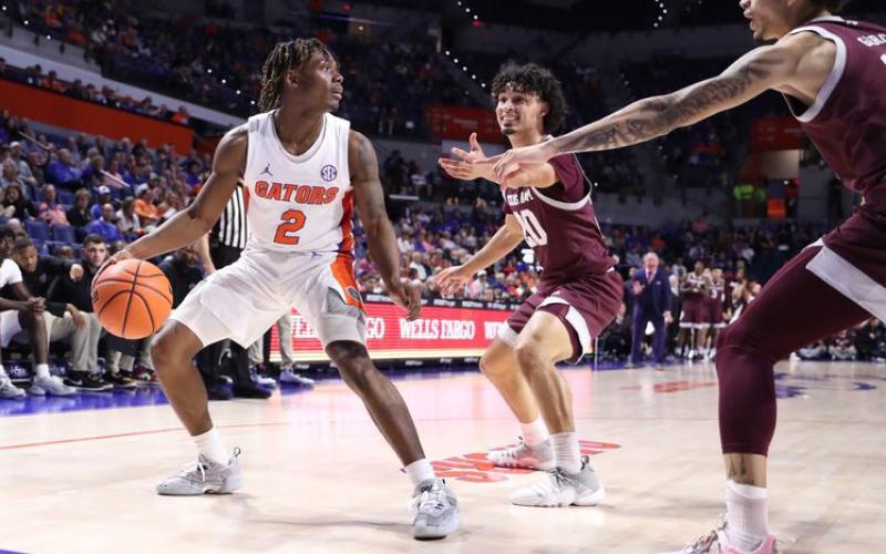Florida guard Trey Bonham looks to pass out of a double team during Wednesday's game against Texas A&amp;M in Gainesville. (MADDIE WASHBURN/UAA Communications)