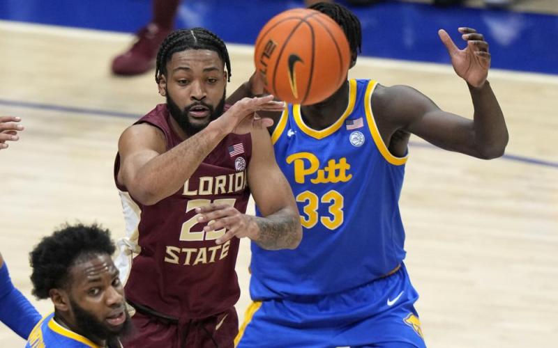 Florida State guard Darin Green Jr. gets off a pass with Pittsburgh center Federiko Federiko defending during Saturday's game in Pittsburgh. Florida State won 71-64. (GENE J. PUSKAR/Associated Press)