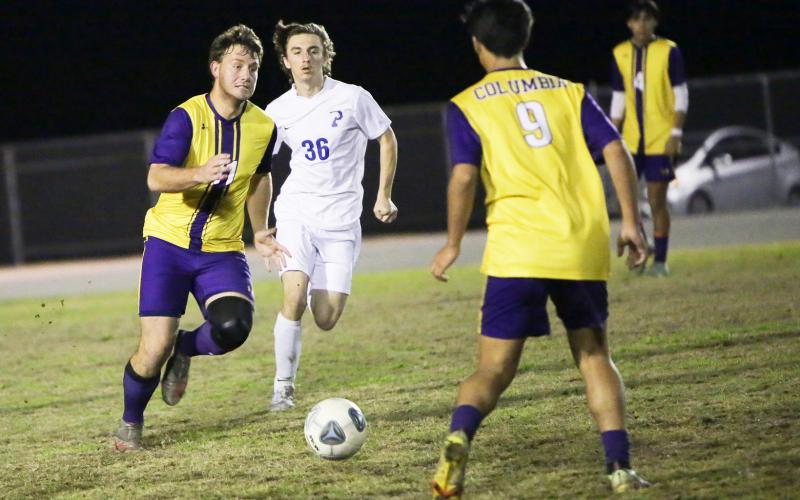 Columbia’s Mickey Johnson (11) passes to teammate Bryson Kyi (9) during Tuesday’s match against Palatka. (BRENT KUYKENDALL/Lake City Reporter)