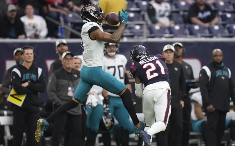 Jacksonville Jaguars wide receiver Marvin Jones Jr. (11) makes a catch over Houston Texans cornerback Steven Nelson (21) on Sunday in Houston. (ERIC CHRISTIAN SMITH/Associated Press)
