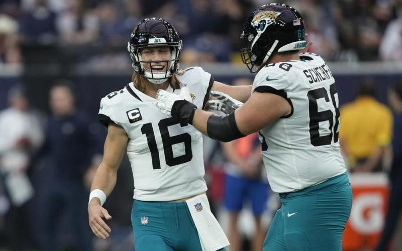 Jacksonville Jaguars quarterback Trevor Lawrence (16) and guard Brandon Scherff (68) celebrate a touchdown against the Houston Texans on Sunday in Houston. (DAVID J. PHILLIP/Associated Press)