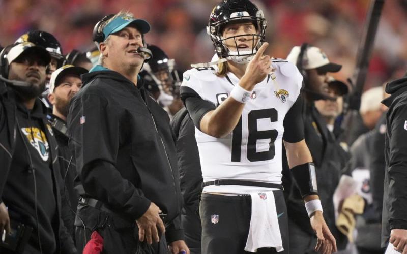 Jacksonville Jaguars quarterback Trevor Lawrence speaks with Jacksonville Jaguars head coach Doug Pederson during Saturday's divisional round playoff game against the Kansas City Chiefs in Kansas City, Mo. (CHARLIE RIEDEL/Associated Press)