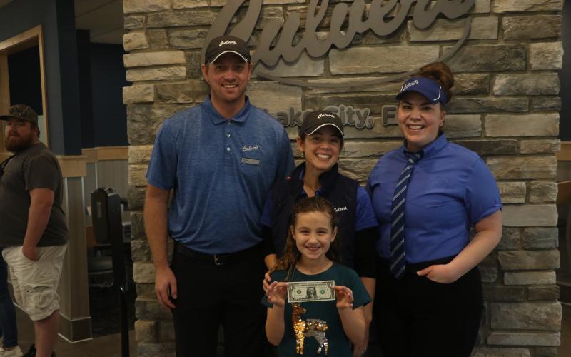 Tyler Goff (back from left), Bess Goff and Chelsea Culver pose with Olivia Medeiros, the Lake City Culver’s location’s first customer, along with the first dollar spent at the restaurant. (MORGAN MCMULLEN/Lake City Reporter)