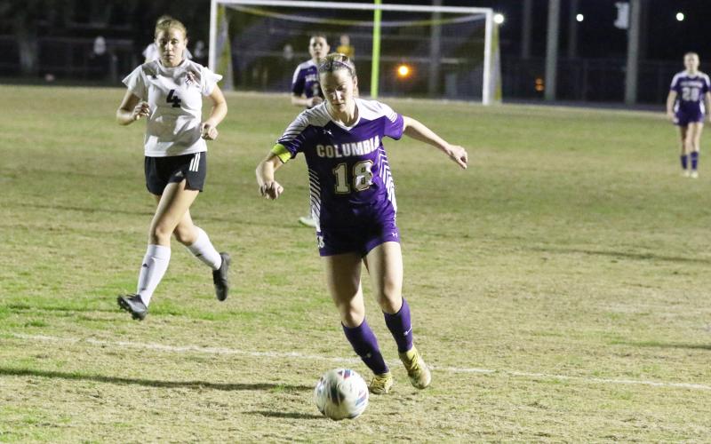 Columbia’s Skyler Ziegaus dribbles the ball up the field against Middleburg on Thursday night. (MORGAN MCMULLEN/Lake City Reporter)