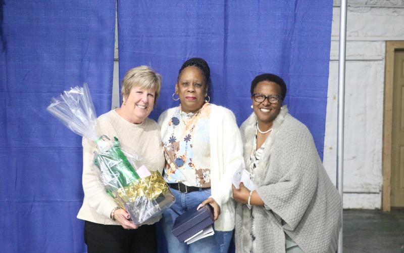 Inez Williams (center), a bus driver, was named Suwannee County’s School-Related Employee of the Year on Thursday during the Teacher of the Year banquet at the Suwannee County Coliseum. (MORGAN MCMULLEN/Lake City Reporter)
