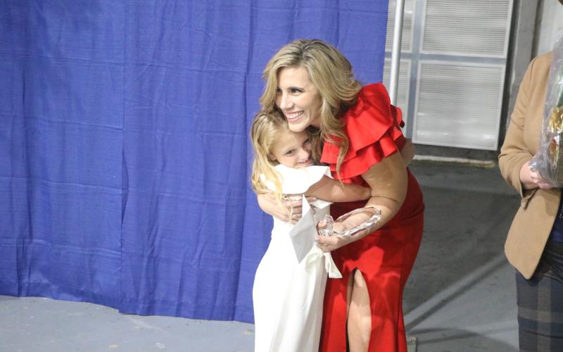 Suwannee Springcrest Elementary teacher Emily Murphy receives a hug from Andi Mae Collins, a former student, after being named Suwannee County’s Teacher of the Year on Thursday at the Suwannee County Coliseum. (MORGAN MCMULLEN/Lake City Reporter)