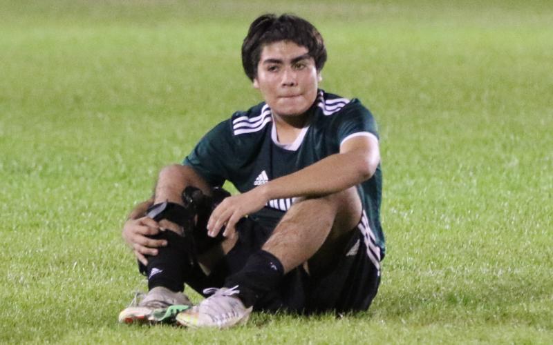 Suwannee’s Kendal Vasquez-Hernandez sits on the field dejected after the Bulldogs lost to Eastside 2-0 in the District 2-4A championship on Tuesday night. (MORGAN MCMULLEN/Lake City Reporter)