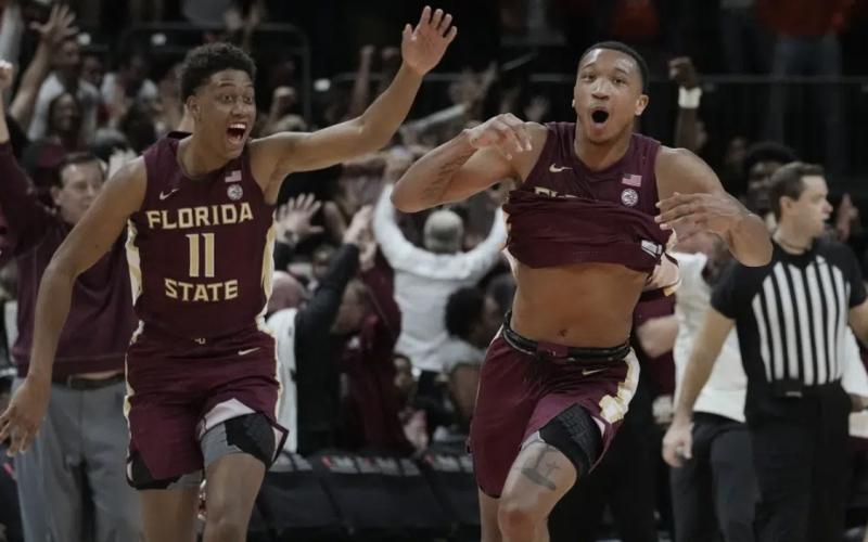Florida State guard Matthew Cleveland (right) reacts after scoring the winning basket against Miami on Saturday in Coral Gables. Florida State defeated Miami 85-84. (MARTA LAVANDIER/Associated Press)