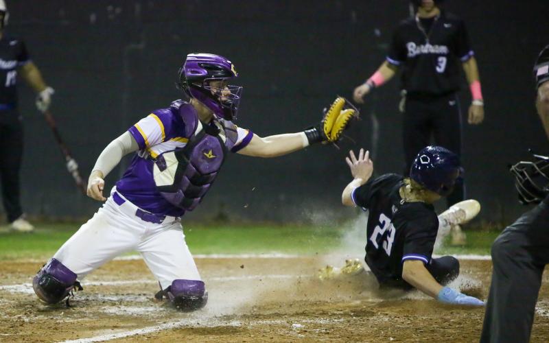 Kolt Myers slides into home plate safely, beating a tag from Columbia catcher Hayden Gustavson on Wednesday night. (BRENT KUYKENDALL/Lake City Reporter)