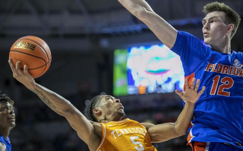Tennessee guard Zakai Zeigler drives under pressure from Florida forward Colin Castleton during Wednesday's game in Gainesville. (ALAN YOUNGBLOOD/Associated Press)