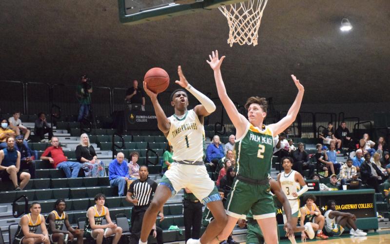 FGC guard Jeremiah Barze goes up for a shot while being defended by Palm Beach State College guard Ryan Moore on Wednesday at the Howard Center. (COURTESY OF FGC)
