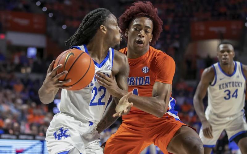 Kentucky guard Cason Wallace drives against Florida guard Niels Lane on Wednesday in Gainesville. (ALAN YOUNGBLOOD/Associated Press)