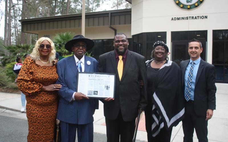 Mercilee Brown (from left) and her Rodney Brown, the first African American student to attend Lake City Junior College stand with Travis George, Lelia Williams and Tony Cardenas during an FGC Black History Month Proclamation ceremony on Tuesday morning. (TONY BRITT/Lake City Reporter)