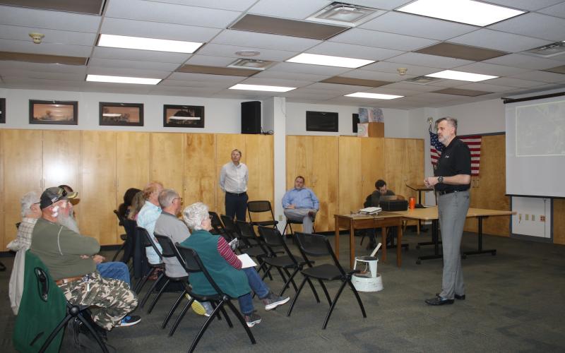 Gerry Dedenbach (standing, far right), CHW executive vice president, details plans for Hunter’s Creek, a planned residential development, that could be built across from the southern entrance of the Southside Sports Complex. (TONY BRITT/Lake City Reporter)