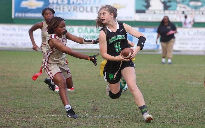 Suwannee quarterback Maci Campbell scrambles away from pressure against Florida High last season. (PAUL BUCHANAN/Special to the Reporter)